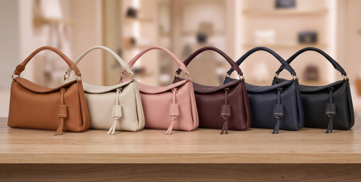 Six colorways of the BOSTANTEN Magnetic Flap Pillow Handbag in full grain pebbled leather lined up on a table