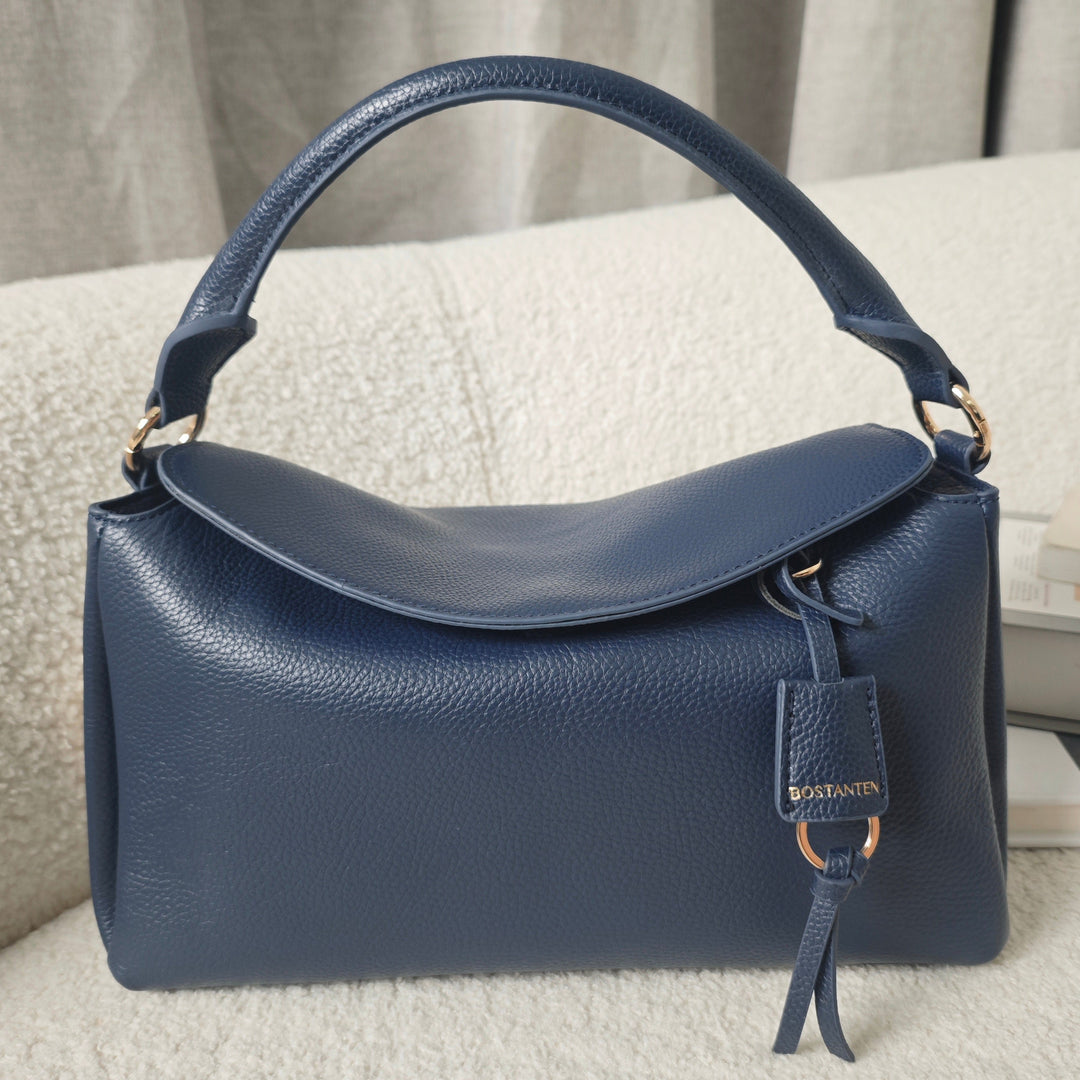 Navy Blue Magnetic Flap Pillow Handbag showcasing its soft pebbled leather texture and magnetic flap closure