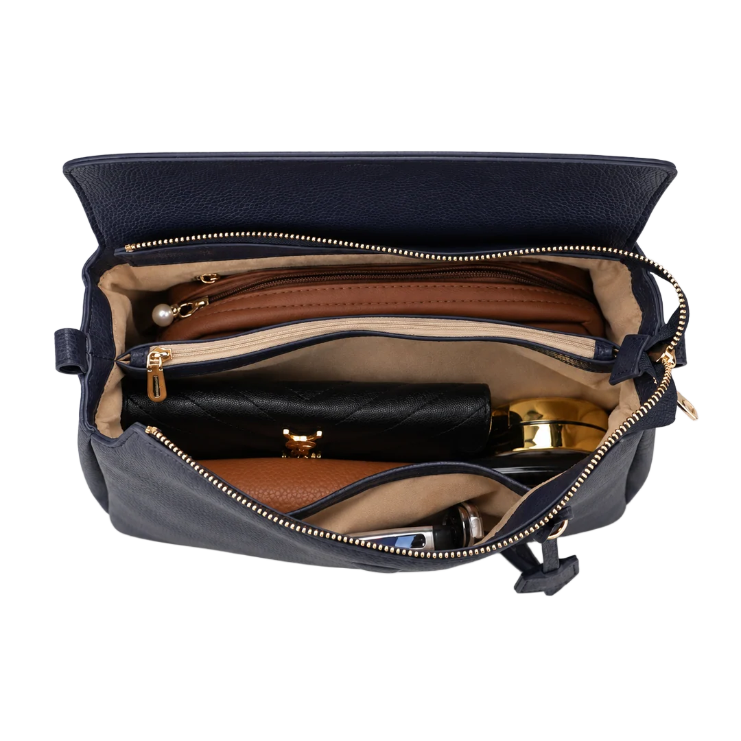 Open interior of the BOSTANTEN Magnetic Flap Pillow Handbag showing layered compartments, slip pockets, and zip pockets